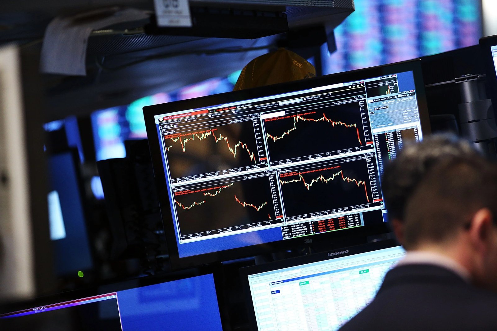 Stock market screens showing declines, for illustration.