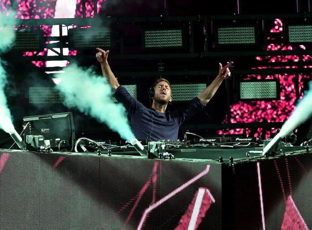 Calvin Harris performing a DJ set before a festival crowd.