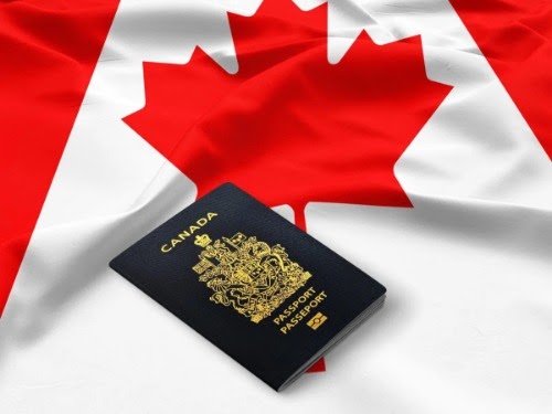 A Canadian passport and flag. Proof-of-citizenship processing reached 34 months in IRCC's October update.