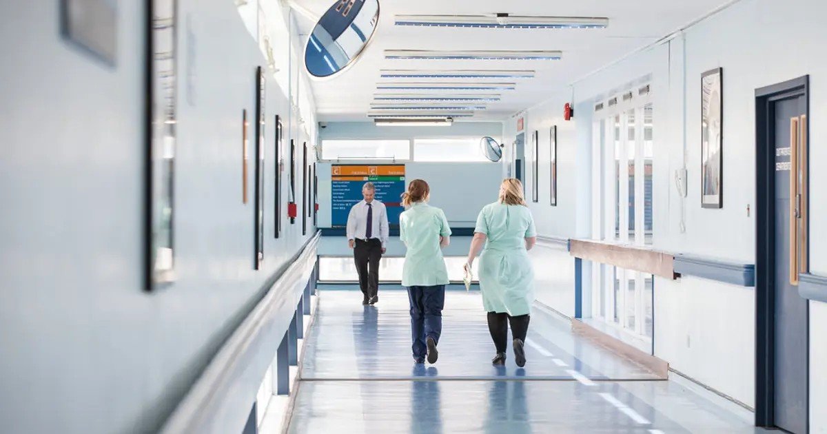 Nurses in a hospital corridor. A new study links for-profit hospital ownership to higher death rates and unsafe staffing.