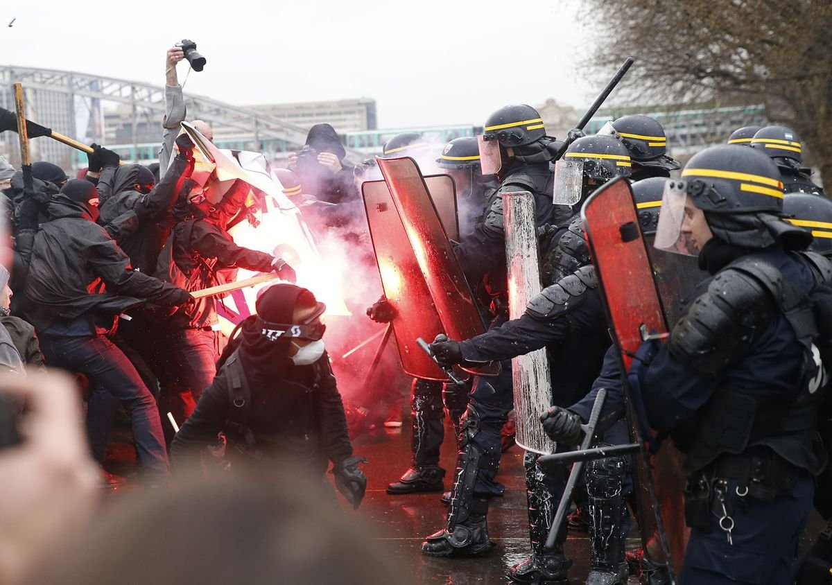French riot police face protesters in Paris. France has suspended police use of stun grenades at high-school protests. (File photo)