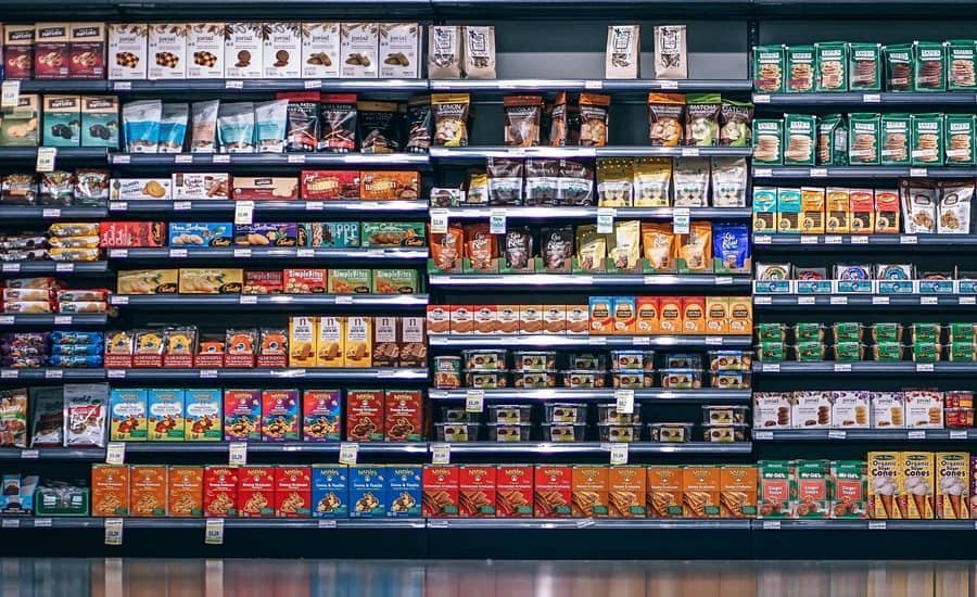 Packaged and processed foods on a supermarket shelf.