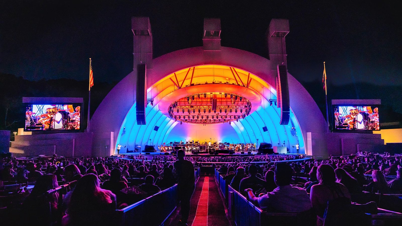 An outdoor amphitheatre concert at night, for illustration.