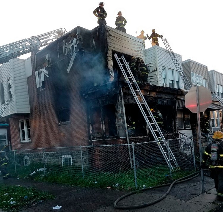 Philadelphia firefighters at a rowhome fire in the city.