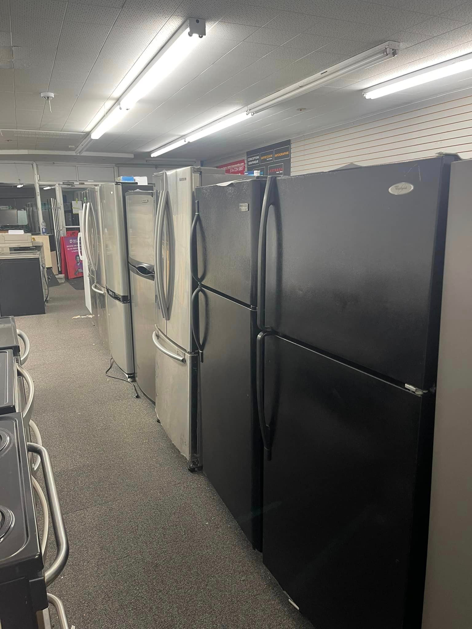 Household appliances on display in a Quebec retail store, now subject to mandatory multi-year repair warranties.