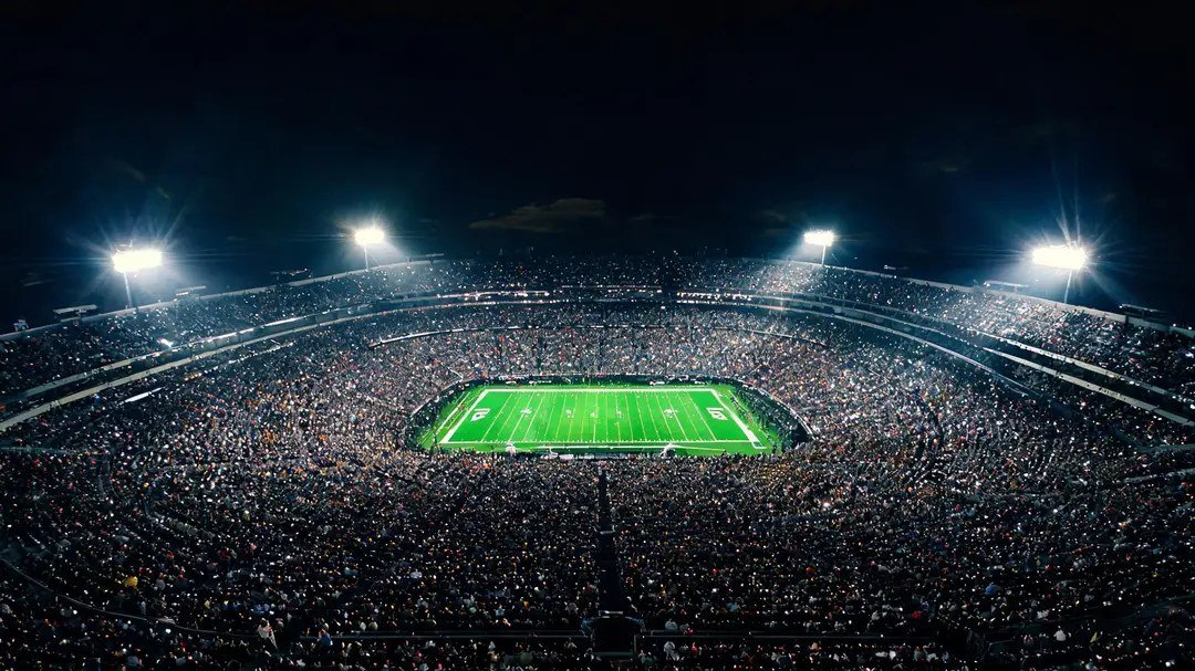 An American football stadium under lights.