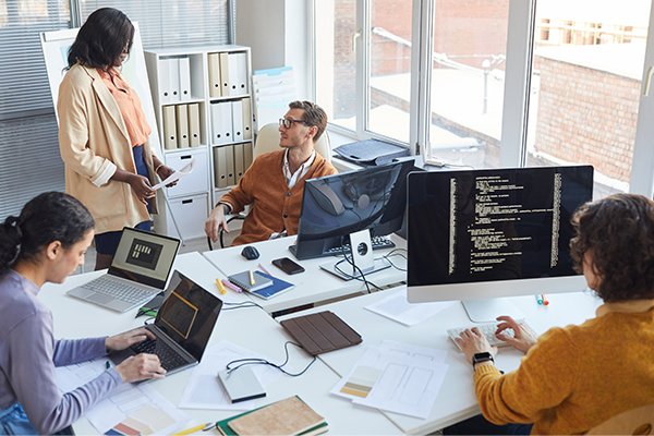 An accounting team reviewing figures on screen.