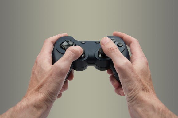 A gamer with a video game controller. New legislation in Congress would guarantee consumers own the games they pay for rather than holding revocable licences.