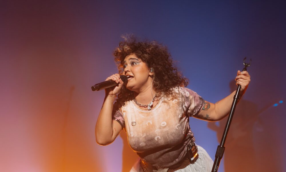 Remi Wolf performing live on stage.