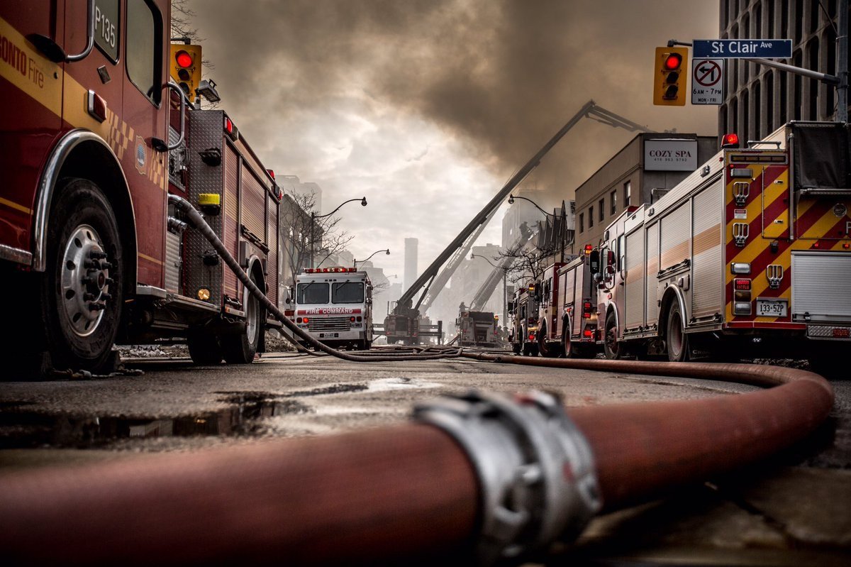 Toronto Fire Services vehicles on a city street, as officials prepared an update on the Matilda Street fire.