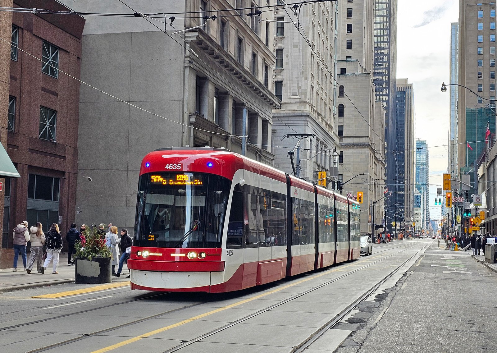 A TTC streetcar travels through downtown Toronto.