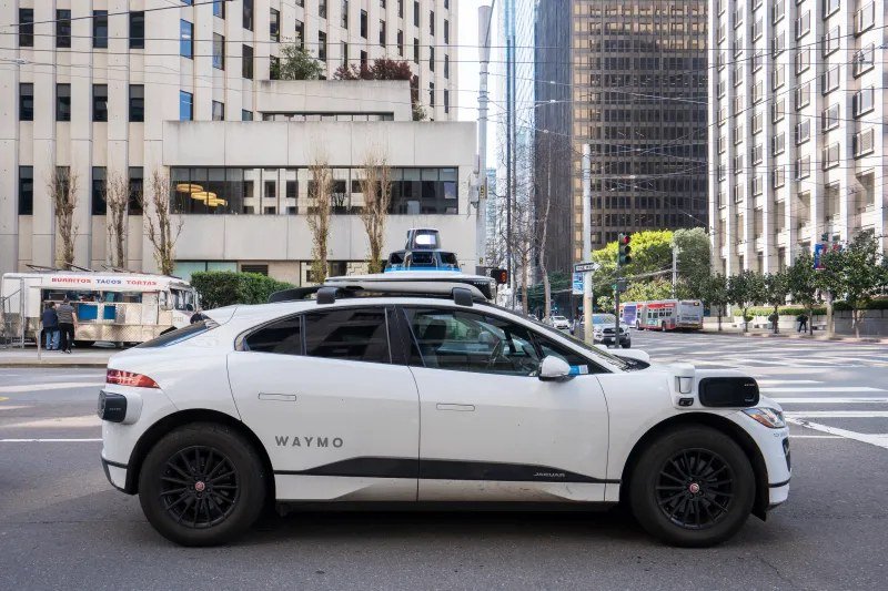 A Waymo autonomous vehicle on a city street.