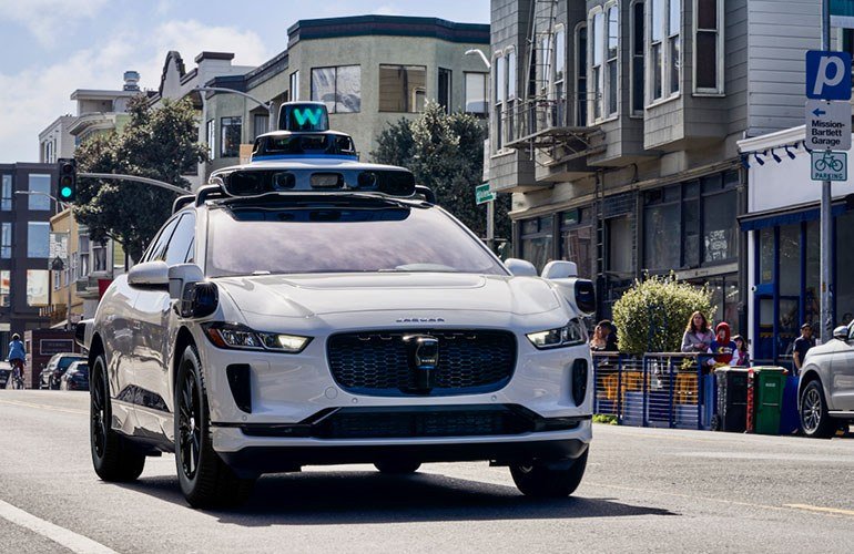 A Waymo robotaxi on city streets; the company closed a $5 billion debut debt deal Thursday.