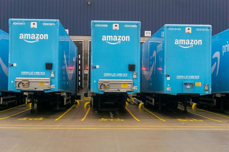 Amazon delivery trucks. The White House slammed Amazon's reported plan to display tariff costs on product prices.