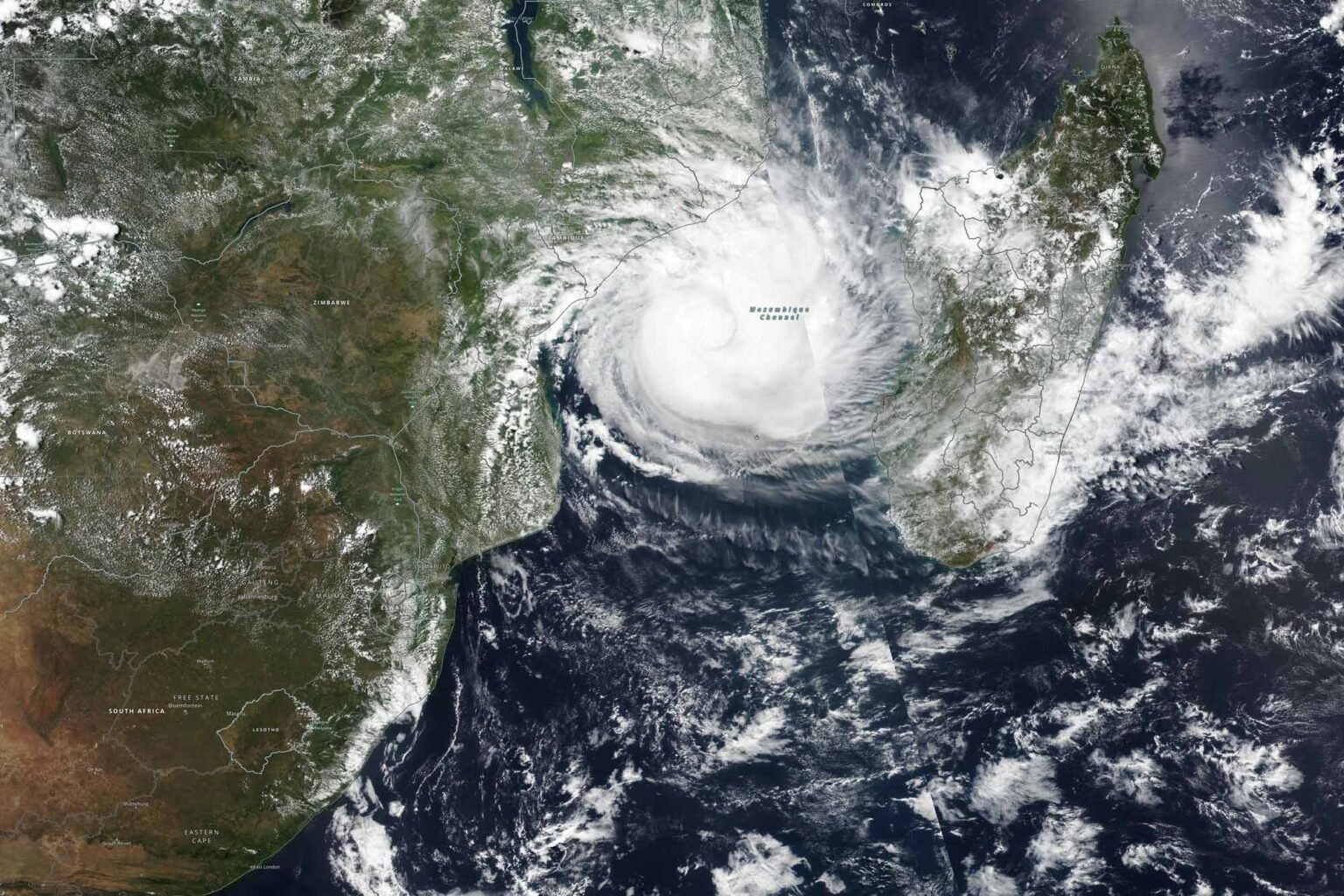 A tropical cyclone swirls over the ocean in a satellite view.
